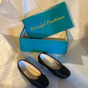 Little girls, colorful creations, black ballet slippers